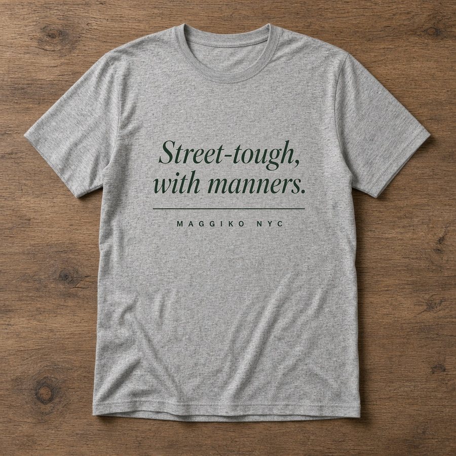 Heather grey t-shirt printed with Street-tough, with manners. in green italic serif and MAGGIKO NYC